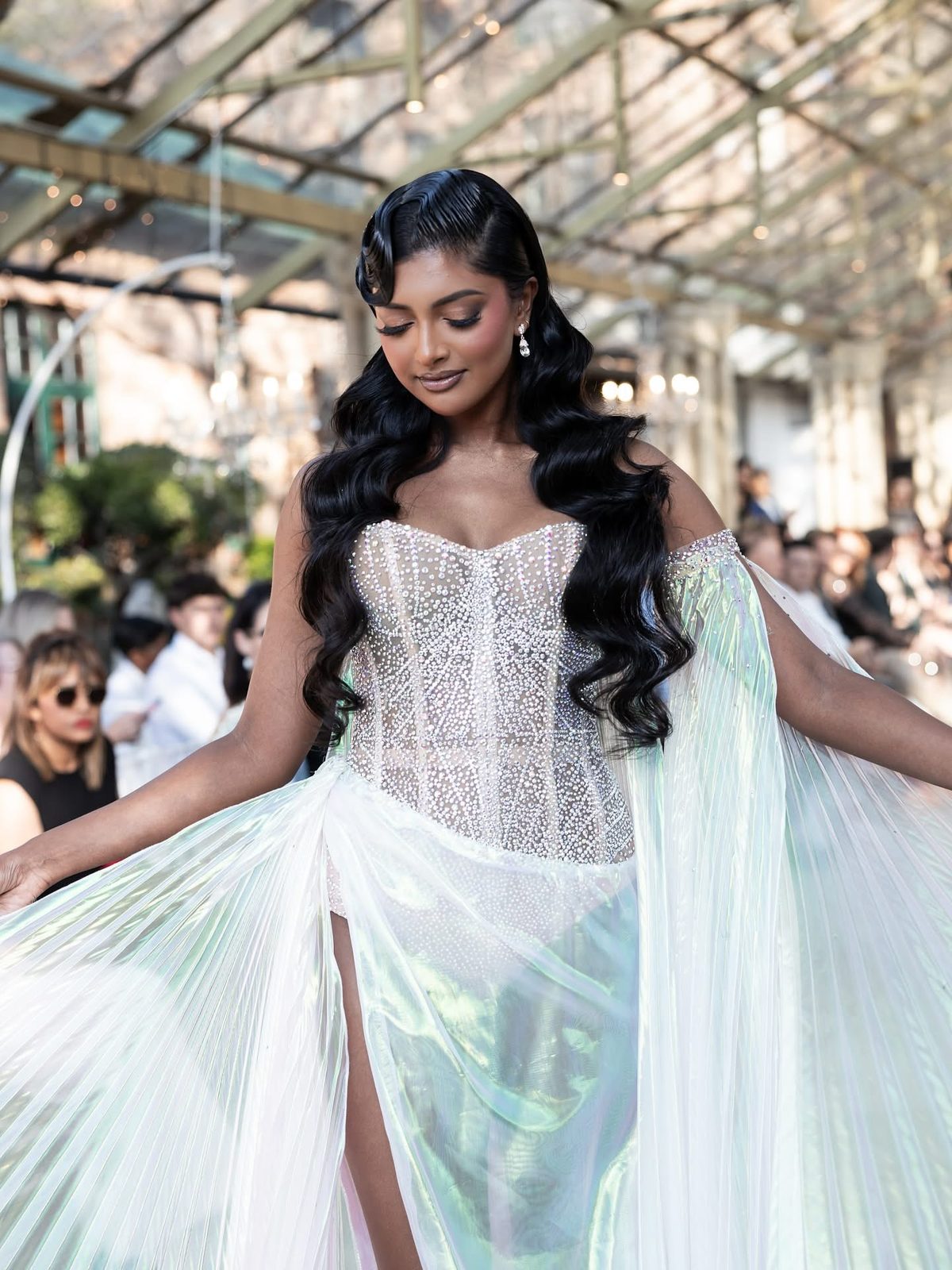 Model with long flowing hair extensions styled in waves