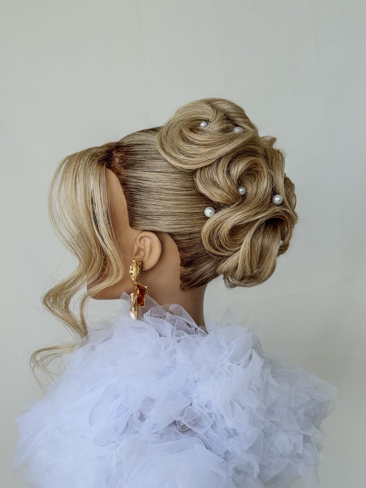 Textured bridal updo with pearl pins